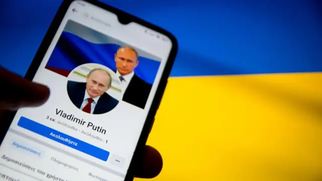 Putin seen on a smart phone in front of a Ukraine flag