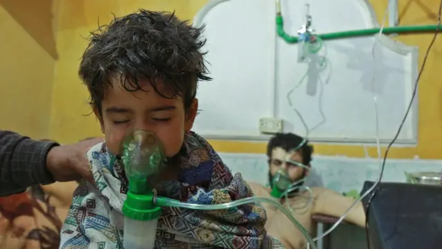 A Syrian child and adult receive treatment after suspected chemical attack in the Eastern Ghouta in early 2018