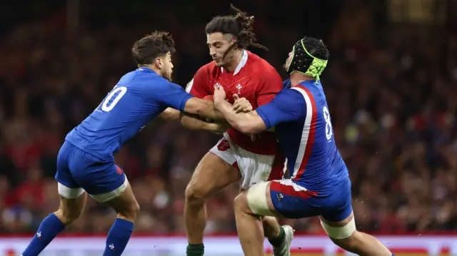 Josh Navidi of Wales tackled