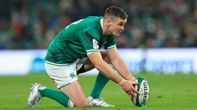 Johnny Sexton lines the ball up on a kicking tee