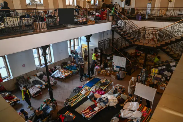 People who fled the war in Ukraine rest inside the old train station building that has been converted for a temporary refugee shelter on March 11, 2022 in Krakow, Poland.