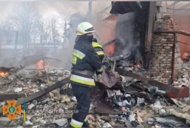 Firefighter tackles blaze after missile strike in Ukraine