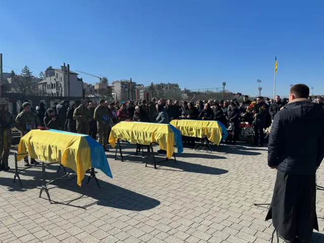 The coffins of Ukrainian soldiers draped in their country's flag