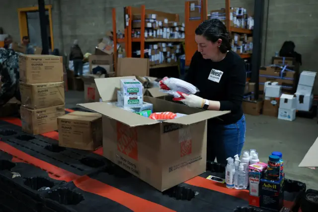 A volunteer charity worker in New Jersey prepares aid packages for displaced Ukrainians