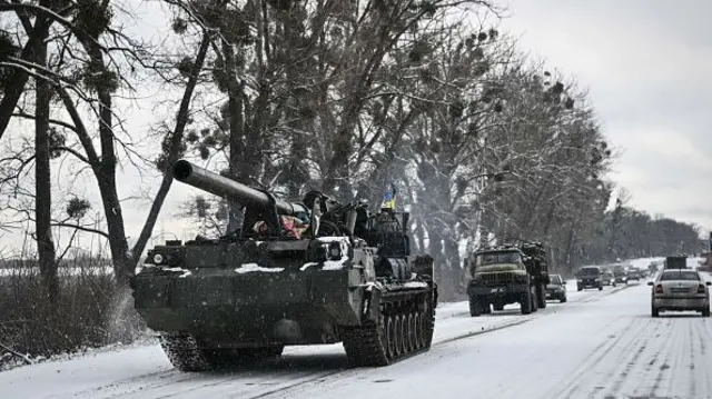 A Ukrainian tank drives along a highway