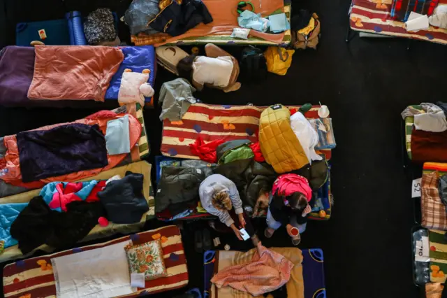 Refugees from Ukraine who arrived to Krakow due to ongoing Russian attacks on Ukraine are seen at a temporary shelter inside the reception point organized in a former historic building of railway station in Krakow, Poland on March 11, 2022.