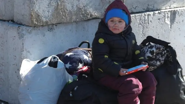 A young girl with bags of her items