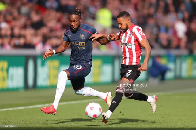 Maxwel Cornet of Burnley battles for possession with Rico Henry