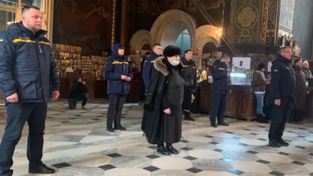 Emergency services personnel attend a ceremony at St Volodymyr's Cathedral in Kyiv, Ukraine