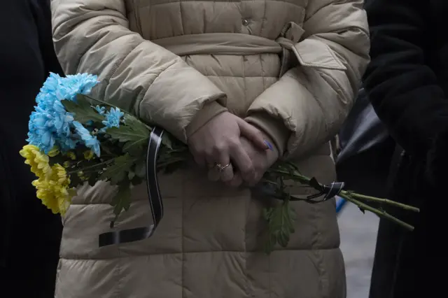 Woman holding flowers for soldier