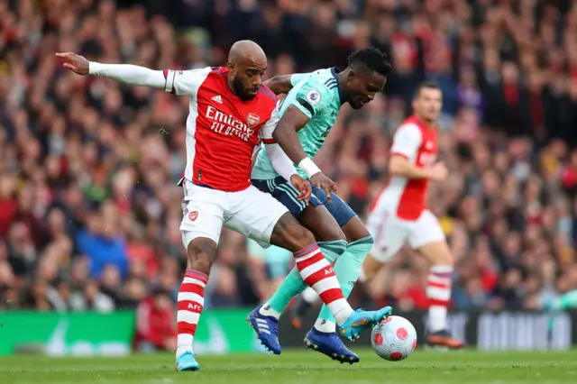 Alexandre Lacazette of Arsenal is challenged by Daniel Amartey