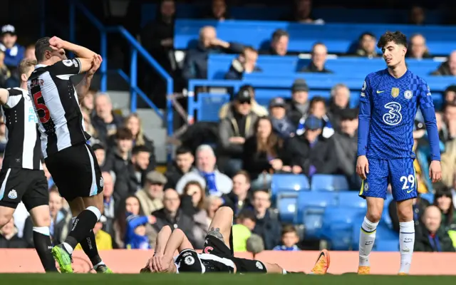 Dan Burn lies prone with Kai Havertz watching on as Newcastle players claim the Chelsea forward used his elbow