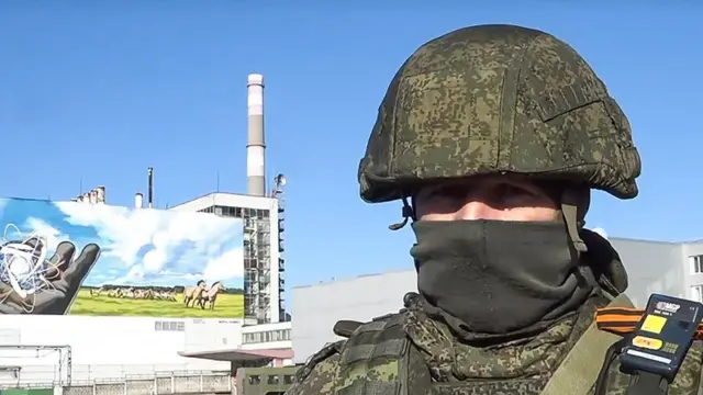 Russian troops guard the perimeter of the plant