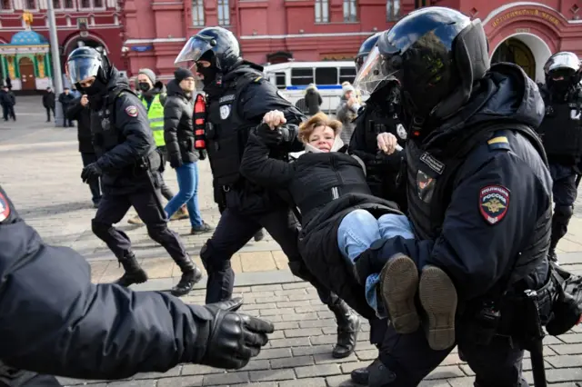 olice officers detain a woman during a protest against Russian military action in Ukraine, in Manezhnaya Square in central Moscow