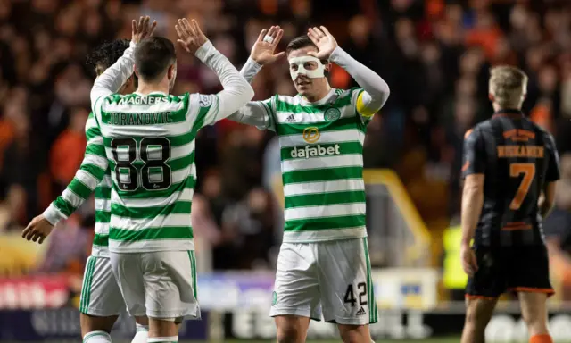 Celtic's Callum McGregor (centre) celebrates making it 1-0 with Josip Juranovic