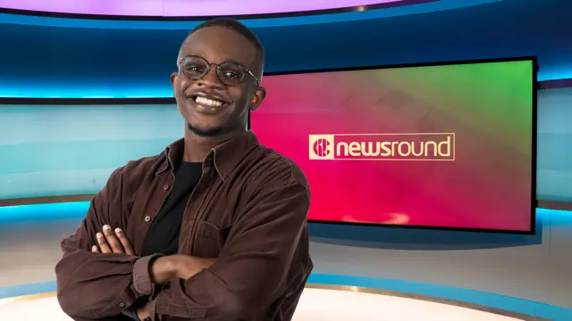 Newsround presenter De-Graft Mensah in the Newsround TV studio