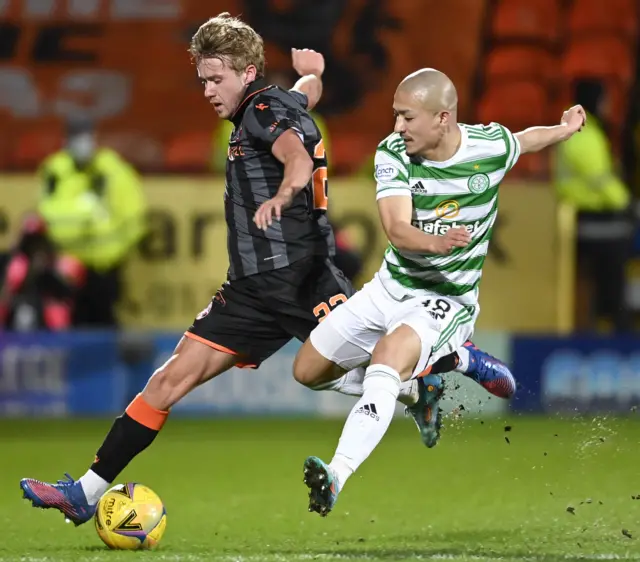 Dundee United's Kieran Freeman (left) battles with Celtic's Daizen Maeda