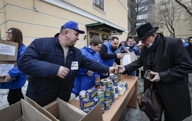 In Russia, members of the Liberal Democratic Party of Russia accept humanitarian aid for Ukrainian refugees during a public action to support Russian troops