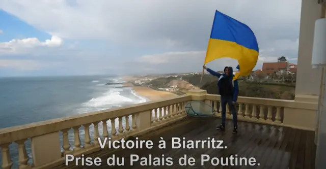 Screenshot of video showing activist with Ukrainian flag