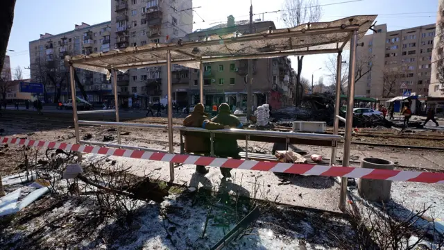 Damage to a bus shelter and street in Kyiv