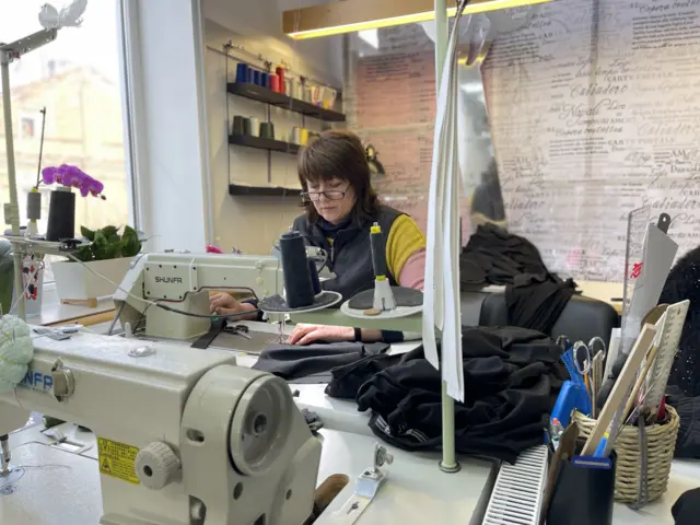 Woman working behind sewing machine