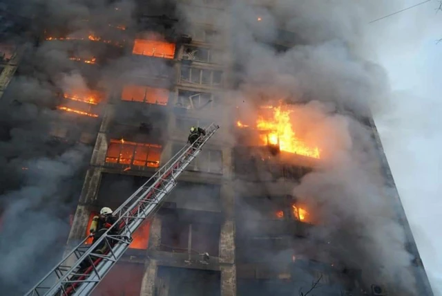 Flames envelop a residential building hit by a Russian strike