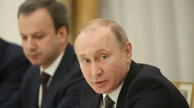 Dvorkovich, seated on Putin's right side during a meeting in 2018