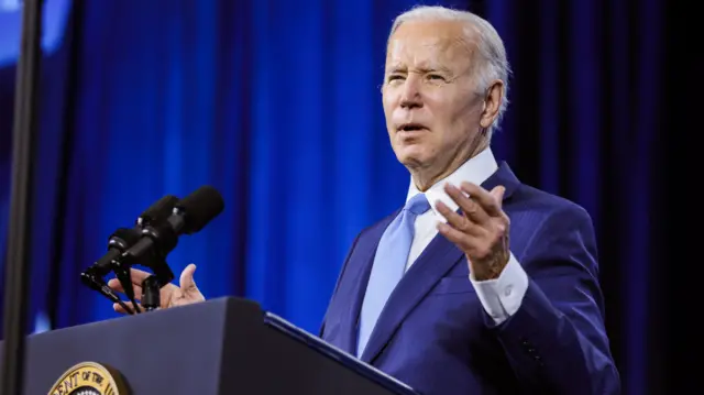 Biden speaking at a podium