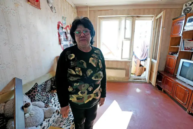 Tetyana in the damaged Kyiv apartment