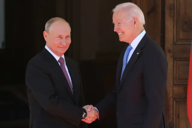 Putin and Biden greet each other at a summit in 2021