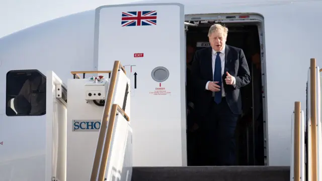 Boris Johnson steps off a plane