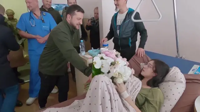 Volodymyr Zelensky hands flowers to injured 16-year-old Katya Vlasenko