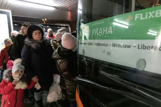 Ukrainian refugees lining up for buses departing to Liberec, Czech Republic