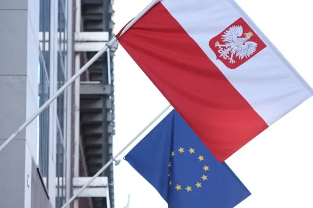 A Polish flag with an EU flag