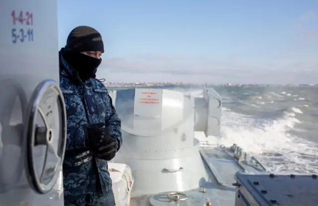 A Ukrainian navy sailor is seen on board an armoured gunboat