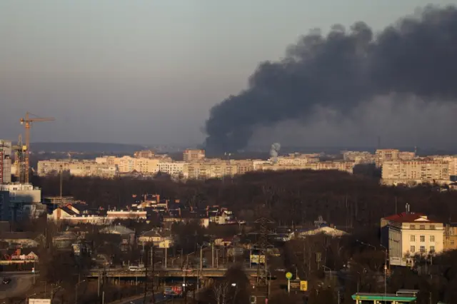 Smoke rises over Lviv after Russian cruise missiles hit an aircraft repair plant on the outskirts of the city in western Ukraine