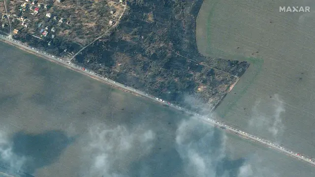 A long line of cars evacuating the besieged port city of Mariupol in the south; some 350,000 people are said to be trapped in the city