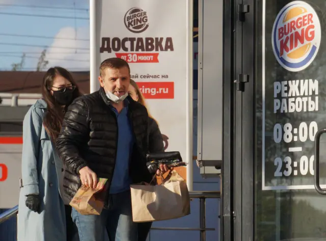 People outside a Burger King outlet in Russia