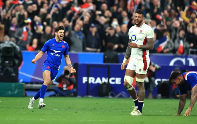 Courtney Lawes (right) looks on as Romain Ntamack celebrates France's Grand Slam