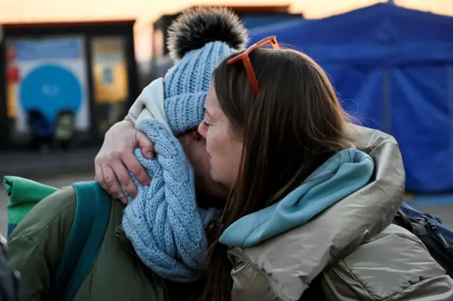 Ukrainian women cry after crossing Ukrainian-Romanian border in Siret, northern Romania, on March 19, 2022