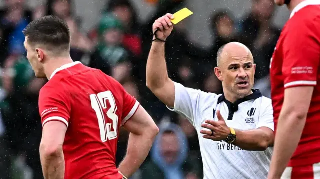 Jaco Peyper shows Josh Adams a yellow card