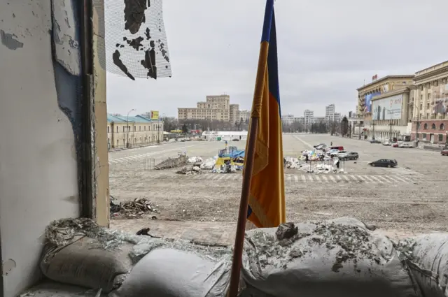 A Ukraine flag  inside a damaged government building, in the aftermath of a shelling in downtown Kharkiv