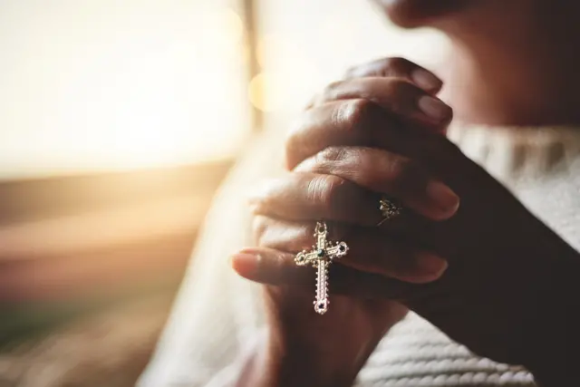 Stock image of someone praying