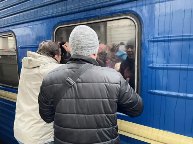 Father wave goodbye at Dnipro station