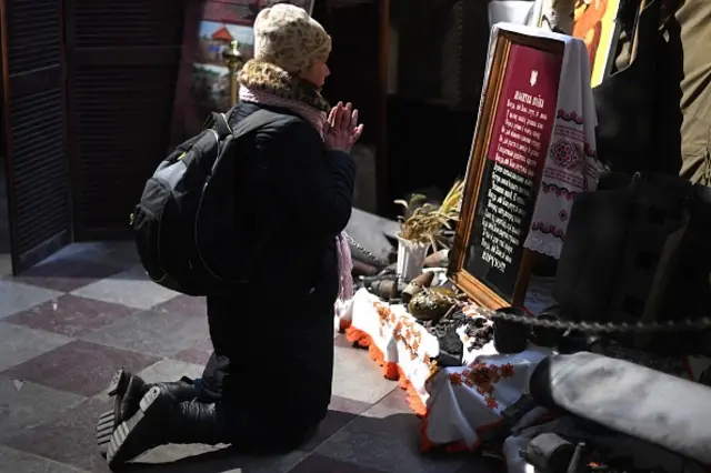 A person prays in a church in Lviv