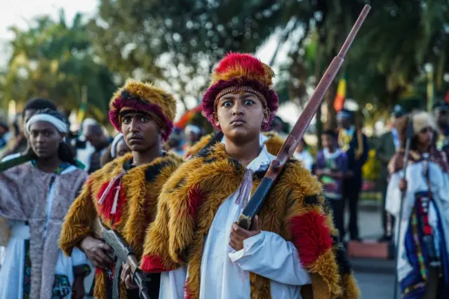 Young boys at the commemoration with guns