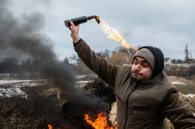 A Ukrainian civilian throws a petrol bomb