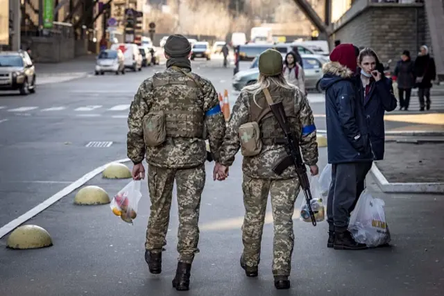 Ukrainian soldiers walk hand in hand