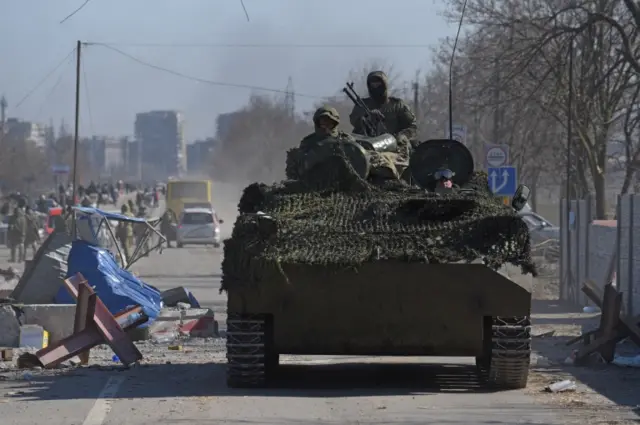 Pro-Russian separatists ride on a tank