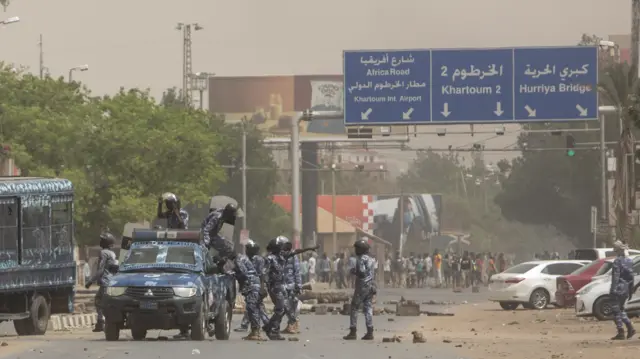 Sudanese policemen near a police truck during a recent demonstration